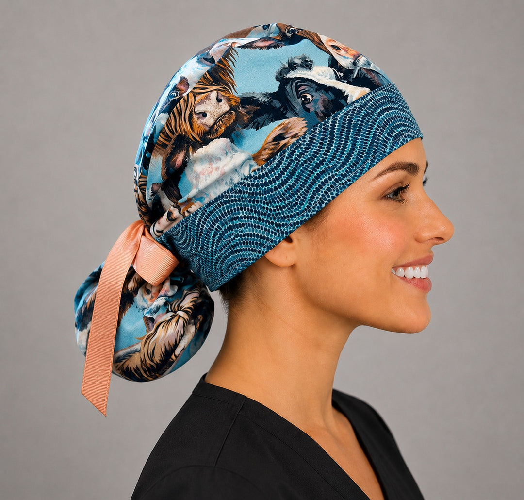 Highland cow ponytail scrub cap side view with gathered pouch for long hair and orange grosgrain ribbon