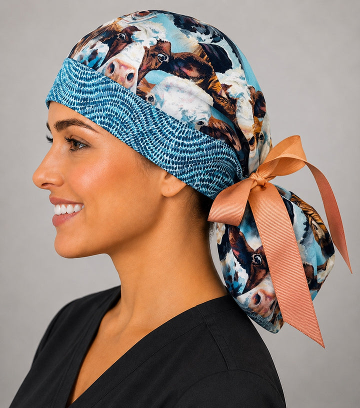 Highland cow ponytail surgical cap left side profile showing long hair pouch and peach ribbon bow tie-back
