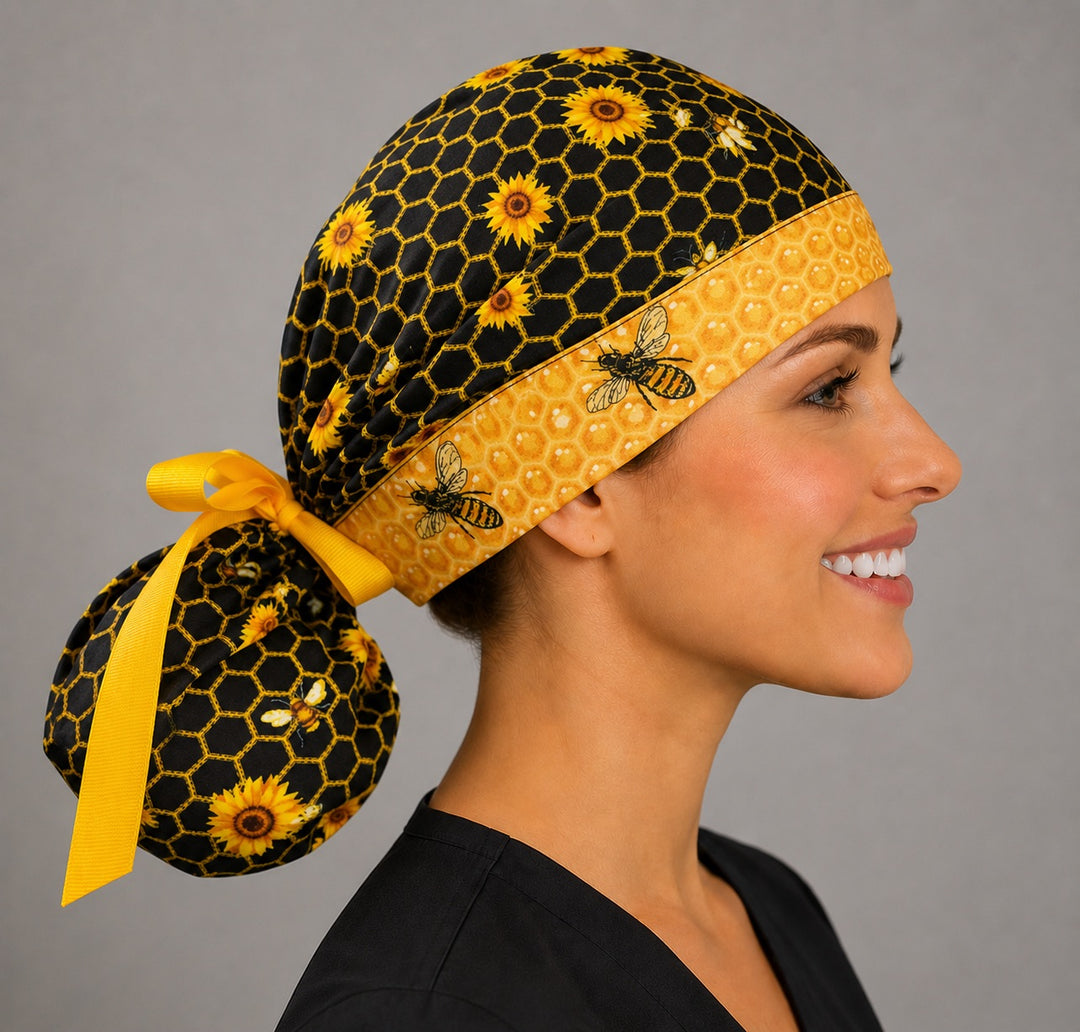 Honey bee honeycomb ponytail surgical cap left side profile with sunflowers, bees and gold ribbon tie-back