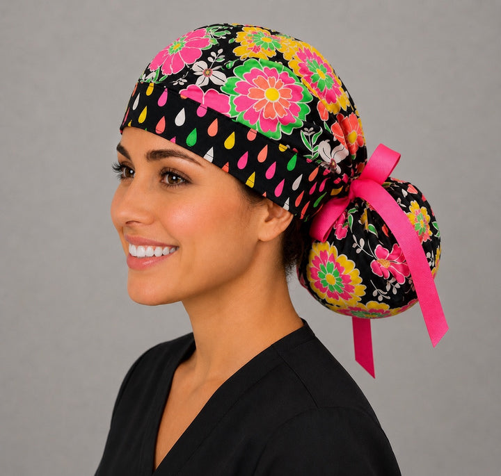 Three-quarter angle of neon floral ponytail scrub cap showing deep pouch for long hair and ribbon bow
