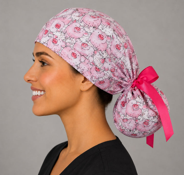 Pink pig ponytail surgical cap left side profile showing gathered ponytail pouch full of cute pigs and hot pink satin ribbon bow