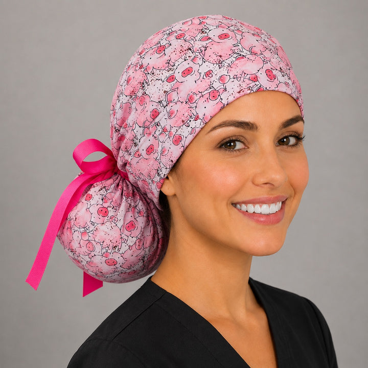 Pink pig ponytail scrub cap right angle showing full ponytail pouch of cute pigs and hot pink ribbon bow on smiling model