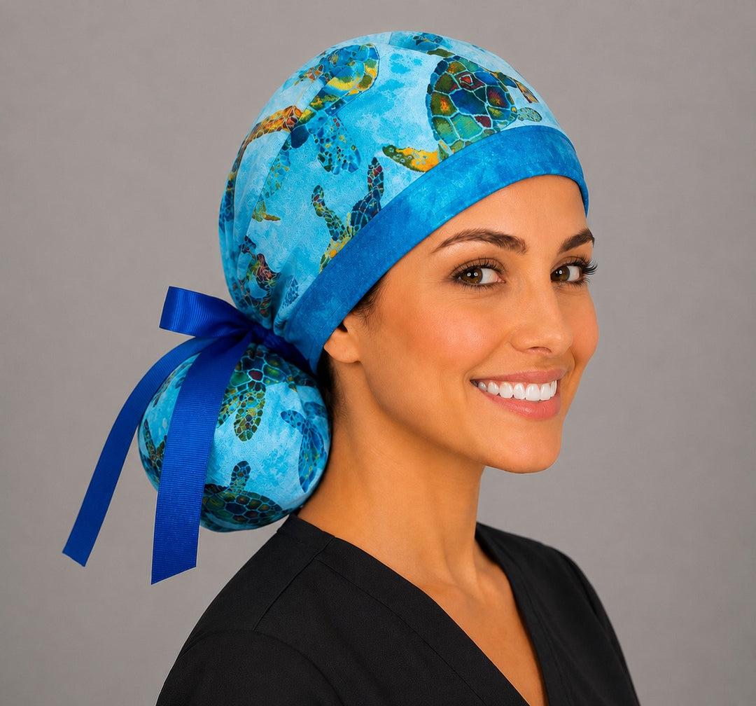Sea turtle tropical ocean ponytail scrub cap right side profile showing colorful turtle print pouch and royal blue grosgrain ribbon tie