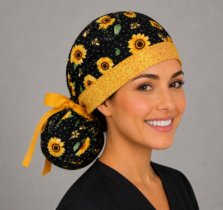 Sunflower and bee ponytail scrub cap back view on mannequin showing gathered pouch of golden sunflowers and honey bees and gold ribbon bow