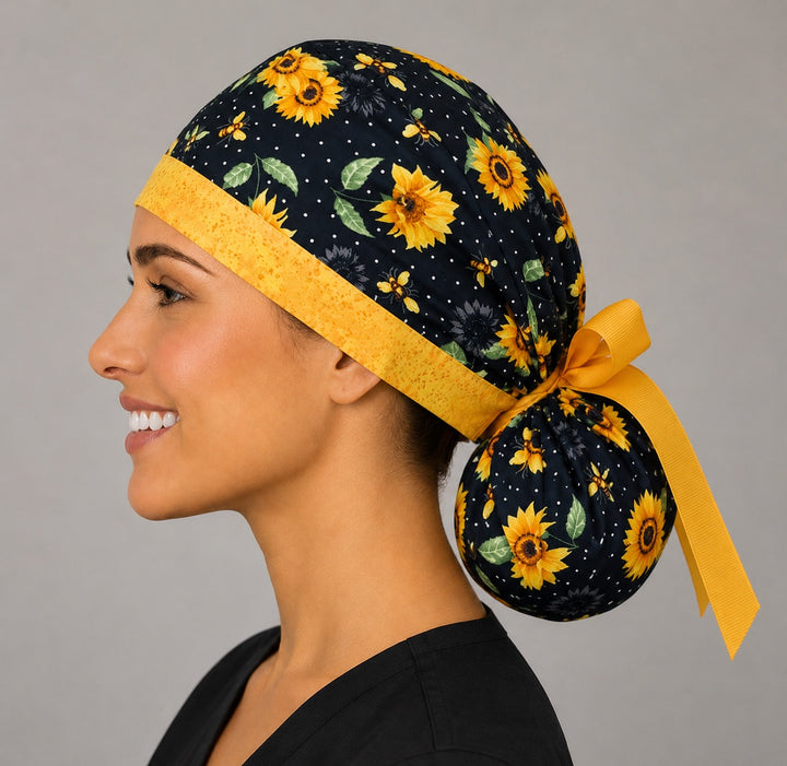 Sunflower and bee ponytail scrub cap right side profile with sunflowers, honey bees and gold speckled band and grosgrain ribbon