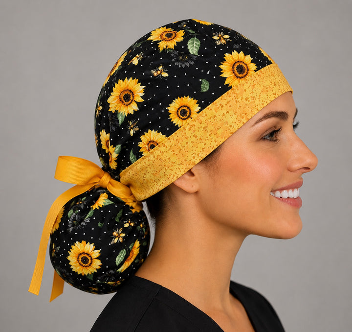 Sunflower and bee ponytail nurse cap right three-quarter angle showing full ponytail pouch of sunflowers and bees and gold ribbon bow