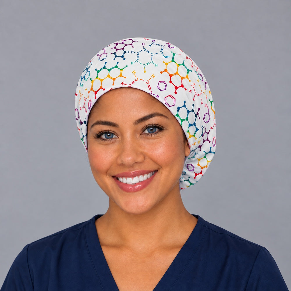 Smiling CRNA in navy scrubs wearing a propofol euro scrub cap, front view of rainbow molecular structures on white framing the forehead