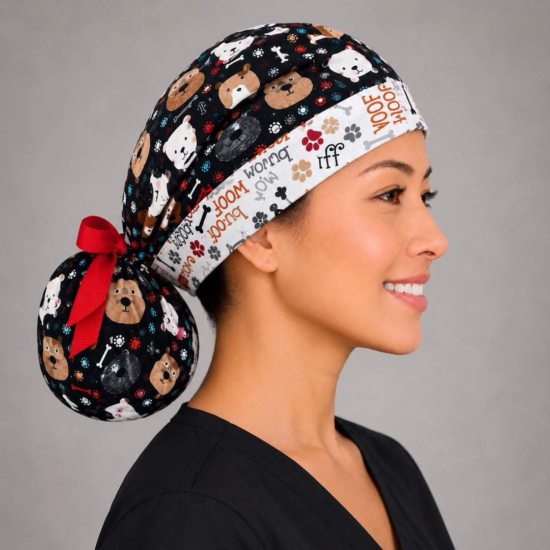Puppy dog lover ponytail scrub cap right side profile showing gathered pouch of dog faces and bones on black with red ribbon bow