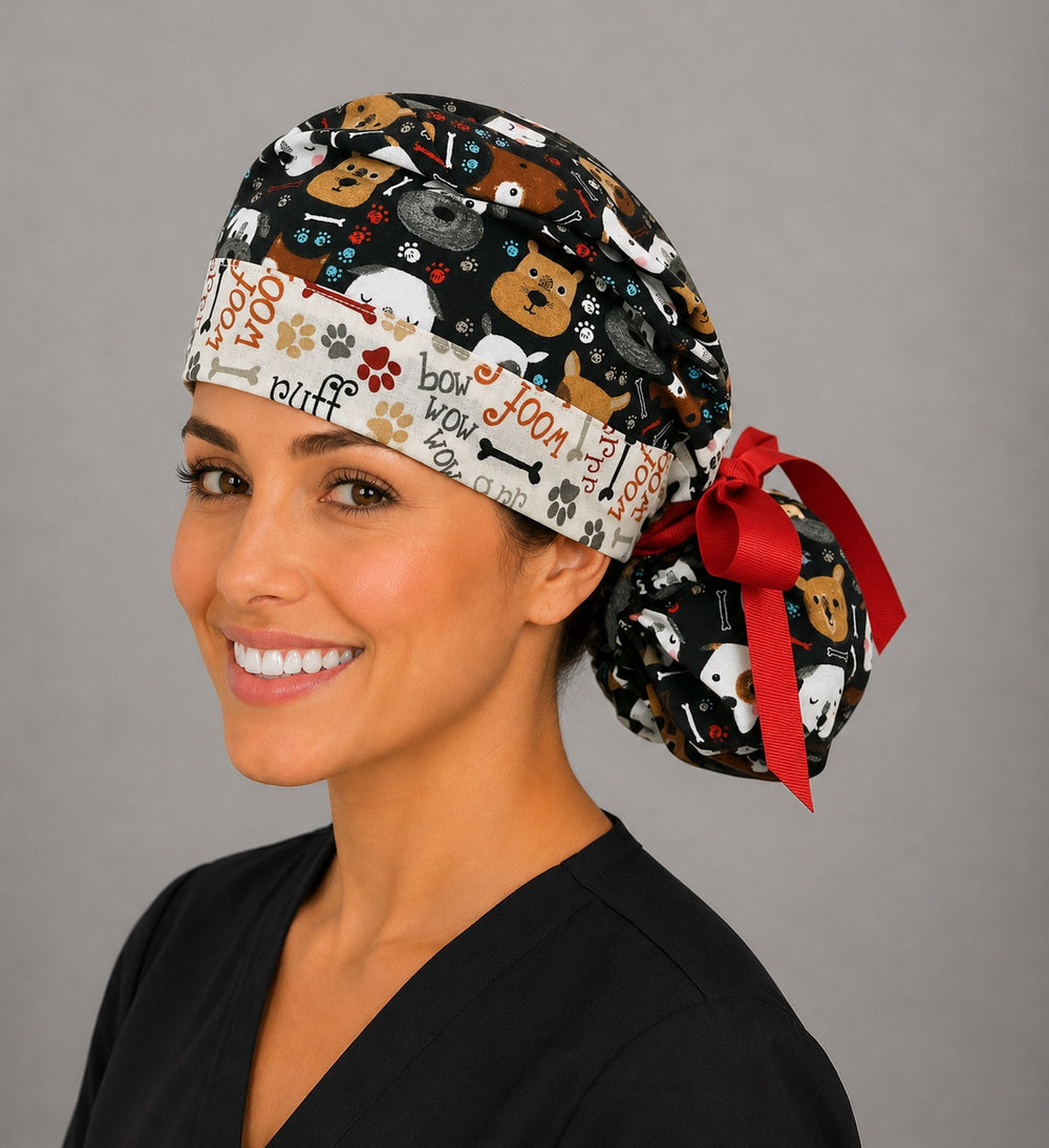 Puppy dog lover ponytail surgical cap right three-quarter angle showing dog faces, paw prints and woof word band with red grosgrain ribbon bow