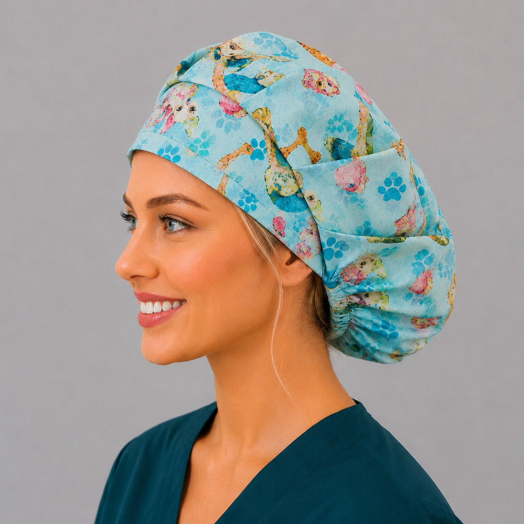 Profile view of the puppy paw-print bouffant surgical hat — colorful dogs on blue, a fun gift for dog groomers and veterinary teams