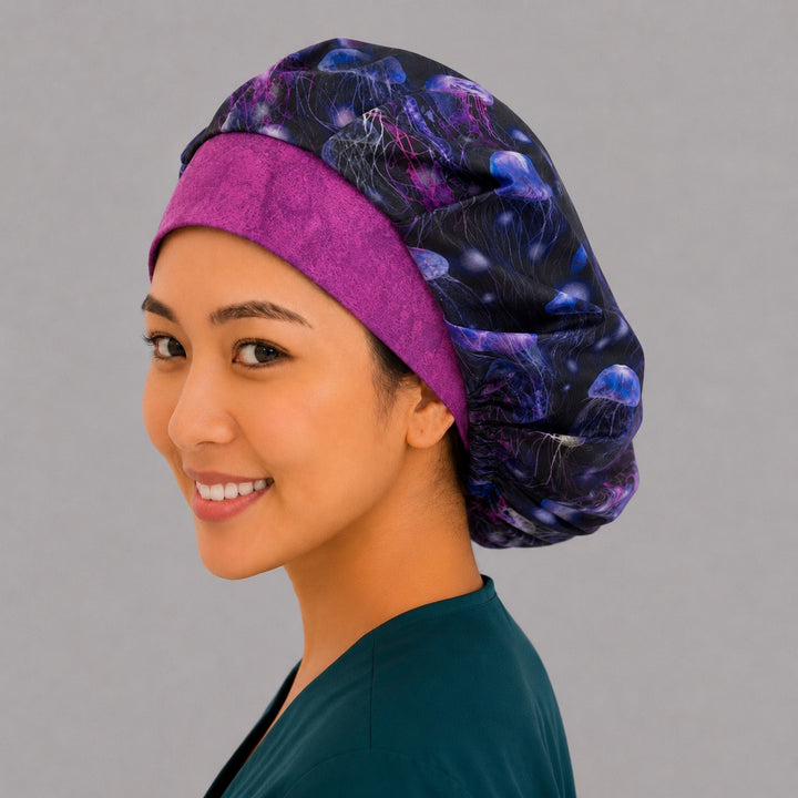 Purple neon jellyfish ocean bouffant surgical cap side view, smiling model — vibrant underwater marine print bouffant scrub hat for women