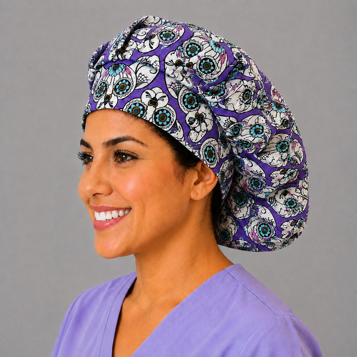 Purple sugar skull cat bouffant scrub cap, left side profile — gold and teal calavera print for OR nurses and vet techs