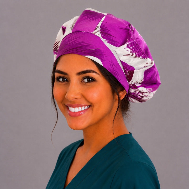 Purple tropical floral bouffant scrub cap right side profile showing violet and plum hibiscus blooms with palm fronds on cream, women&