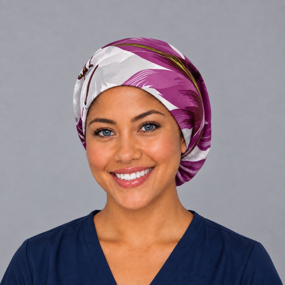 Woman wearing a purple tropical floral Euro scrub cap, front view — magenta and white palm leaves, adjustable women's surgical cap
