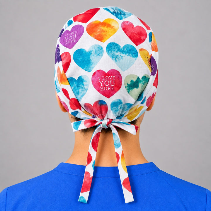 Rear bow ties on rainbow heart scrub hat, unisex Valentine OR cap shown from behind