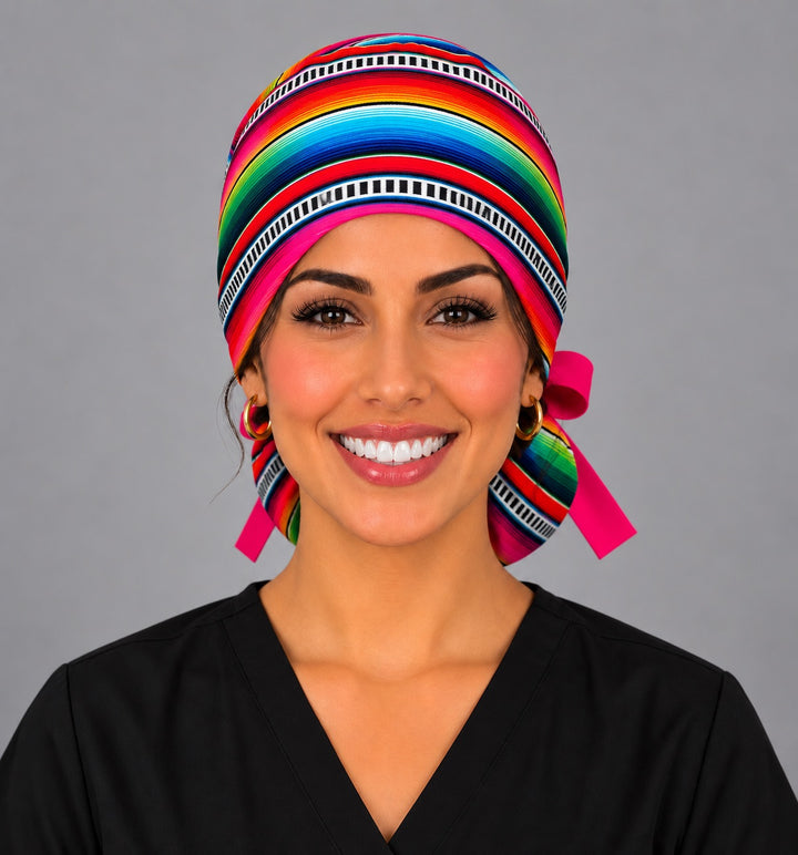 Front view of a rainbow sarape ponytail surgical hat for women, handmade in the USA by OR World