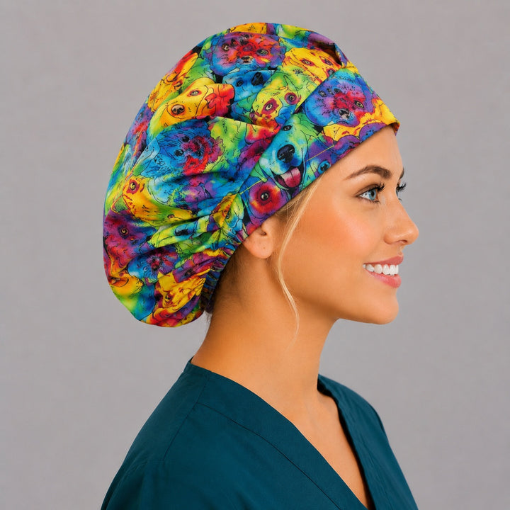 Rainbow watercolor dog bouffant surgical cap left side profile showing colorful puppy portraits in rainbow watercolor, OR World veterinary nurse hat