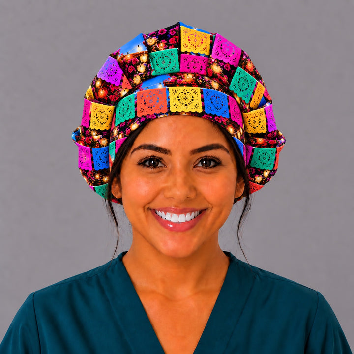 Front view of a realistic papel picado surgical hat in pink, yellow, turquoise and blue, handmade by OR World