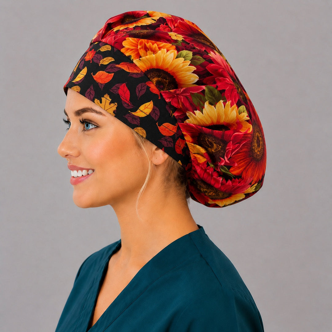 Red and gold sunflower bouffant scrub cap, left angled view — deep gathered fit that secures long thick or braided hair