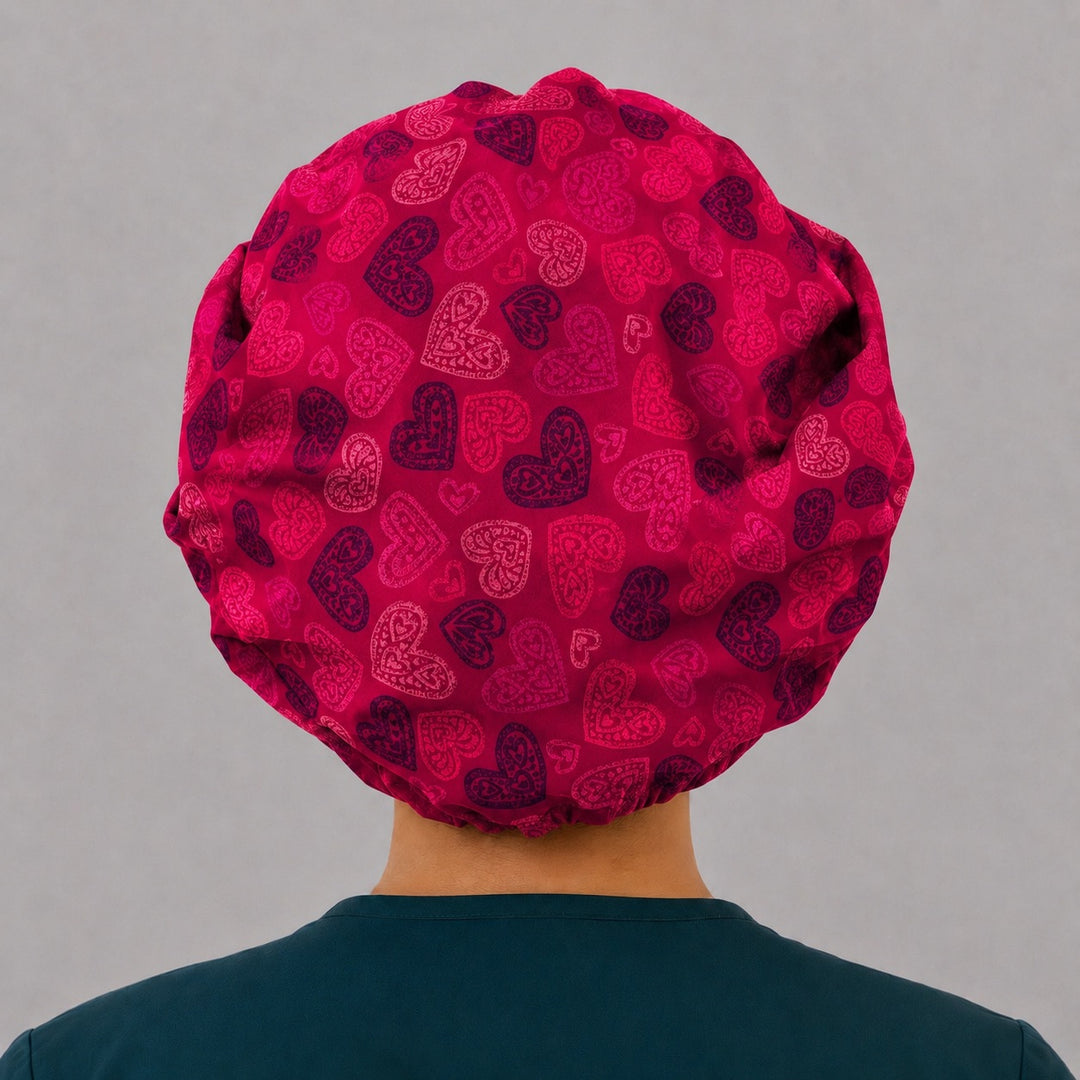 Back view of the red heart bouffant scrub cap — full gathered fit showing lace-filled hearts across the crimson crown