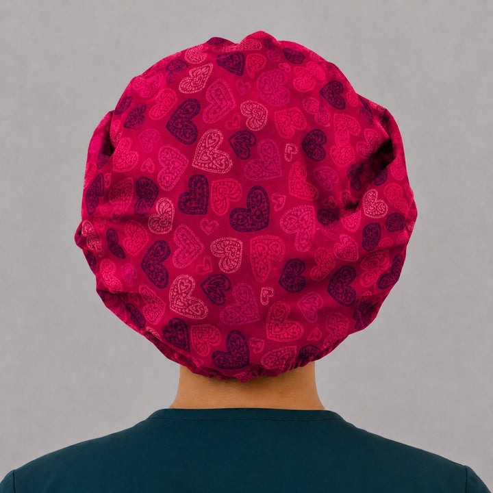 Back view of the red heart bouffant scrub cap — full gathered fit showing lace-filled hearts across the crimson crown