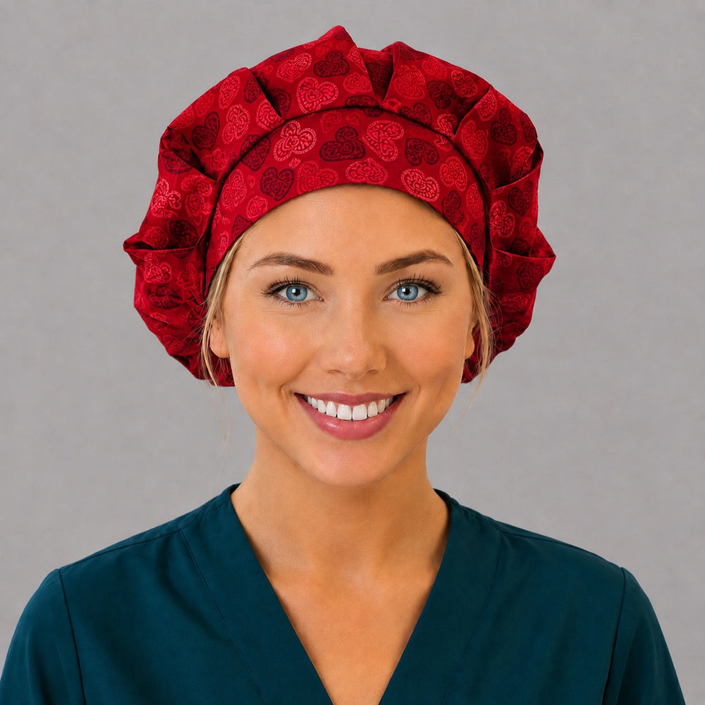 Woman wearing a red heart bouffant scrub cap, front view — lace hearts on cherry red, adjustable women's surgical hat