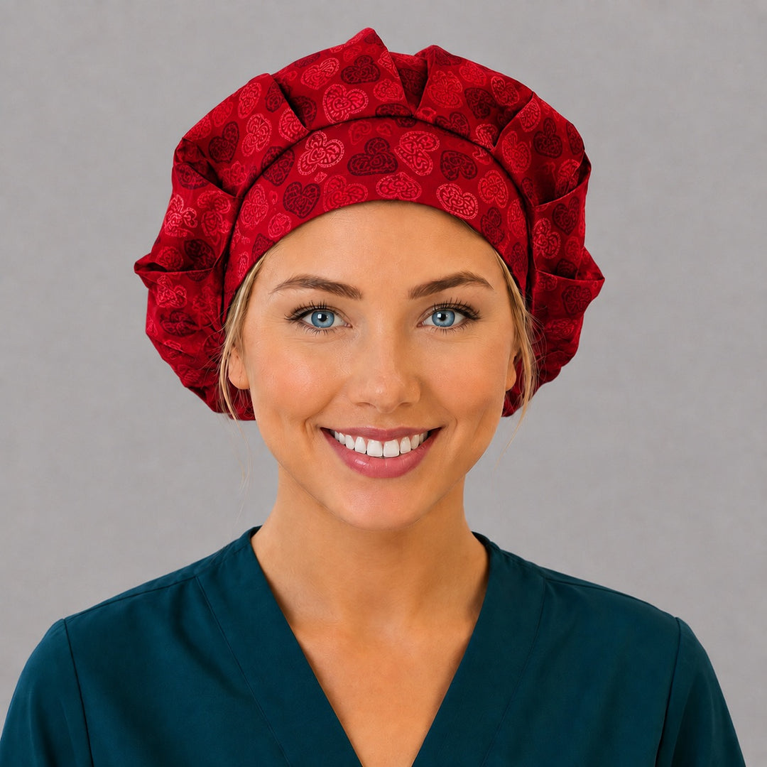 Woman wearing a red heart bouffant scrub cap, front view — lace hearts on cherry red, adjustable women&