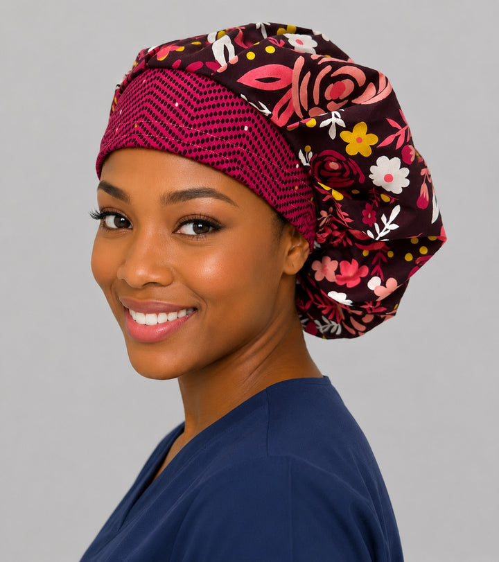 Red rose bouffant surgical cap for women, side smiling view — bold floral print on black, breathable bouffant scrub hat handmade in the USA