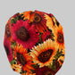 Side view of fall sunflower bouffant scrub cap with autumn leaf band — handmade-in-USA surgical hat, cozy fall gift for nurses & surgeons.