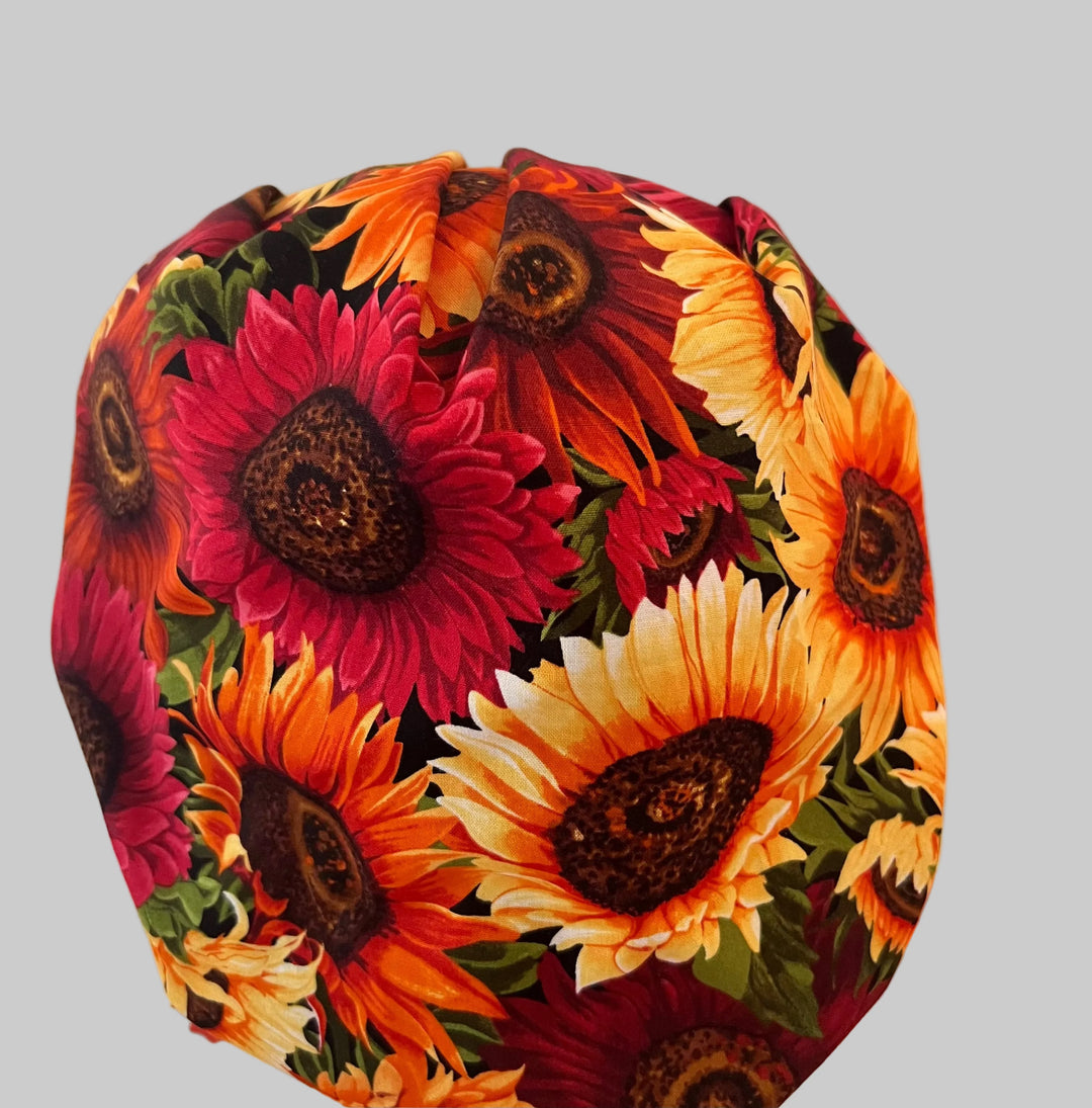 Side view of fall sunflower bouffant scrub cap with autumn leaf band — handmade-in-USA surgical hat, cozy fall gift for nurses &amp; surgeons.