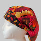 Side profile of red sunflower fall bouffant scrub cap with orworld.net label — handmade-in-USA autumn surgical hat for women with long hair.