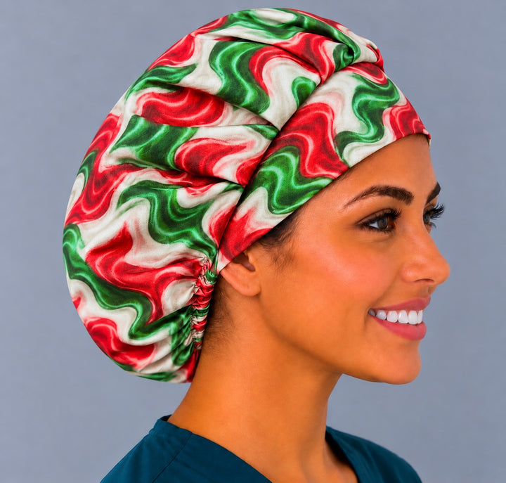 Right profile of a red, white and green bouffant surgical hat, showing the gathered elastic back sitting low at the nape behind the ear