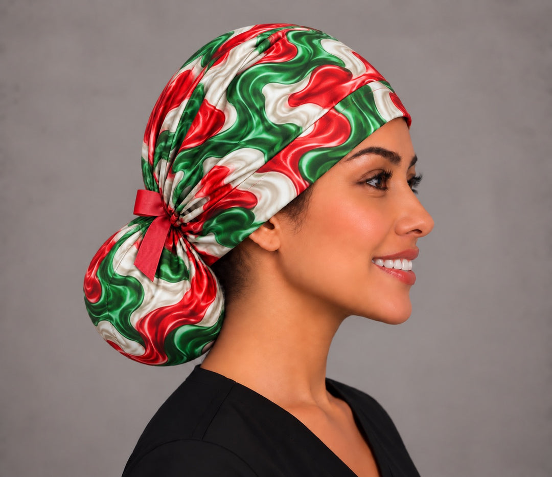 Right profile of a red, white and green ponytail surgical hat, showing the round low bun pouch at the nape and the gathered fabric above it