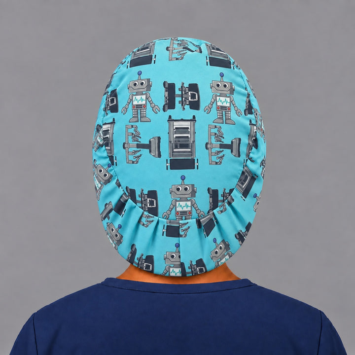 Back view of the robot Euro scrub cap — elastic gathered back showing robots and OR tables across the teal crown