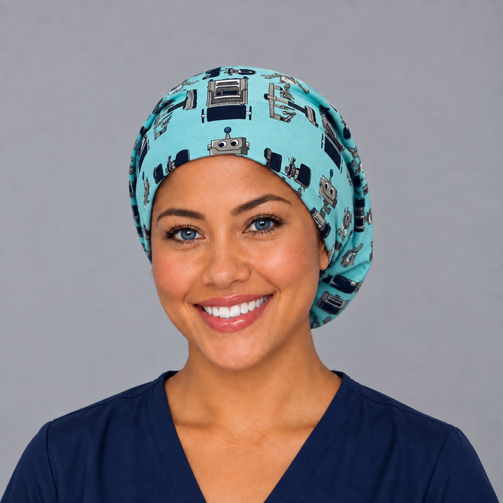 Woman wearing a robot Euro scrub cap, front view — friendly medical robots on teal, adjustable surgical hat for nurses