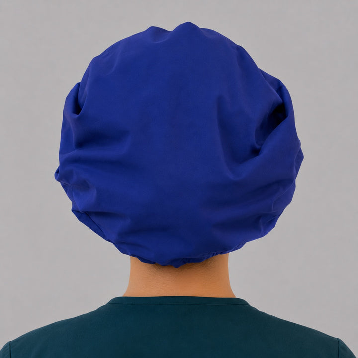 Royal blue bouffant scrub cap back view showing full gathered solid royal blue crown and elastic closure, OR World surgical hat