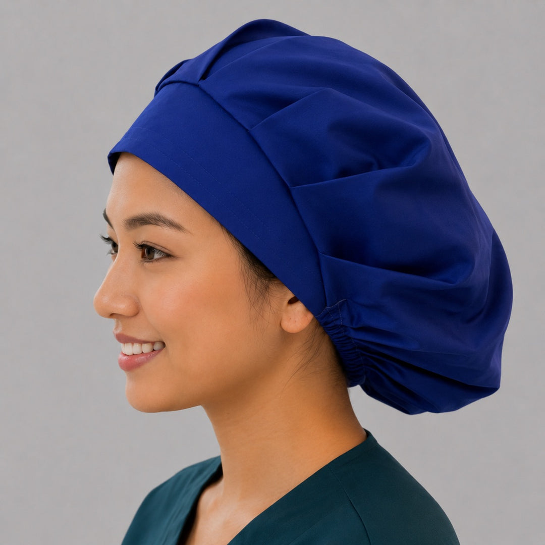 Royal blue bouffant surgical cap left side profile showing thick front band and solid royal blue fabric, OR World nurse hat