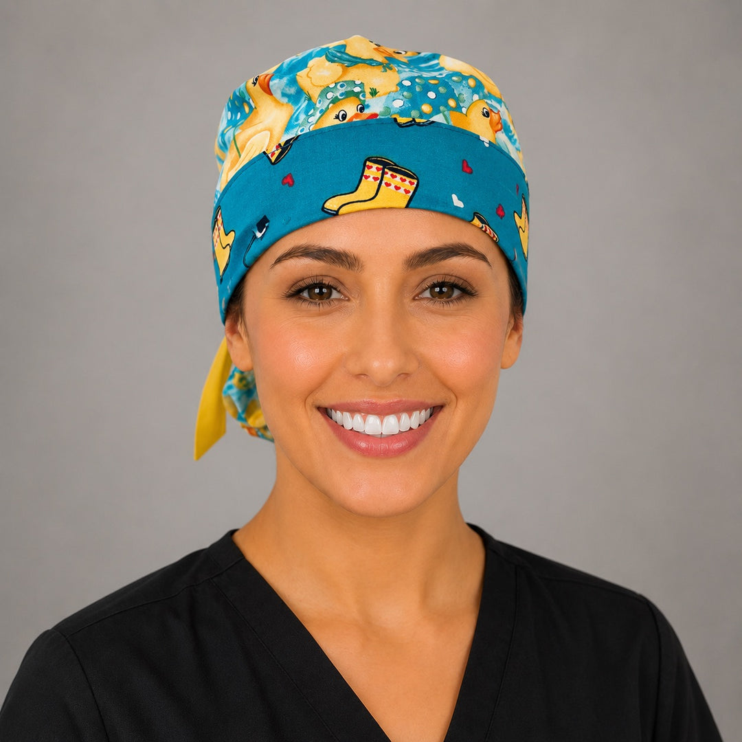 Woman wearing rubber duckies and rain boots ponytail scrub cap, front view smiling with yellow ducks, aqua water and yellow rain boot band