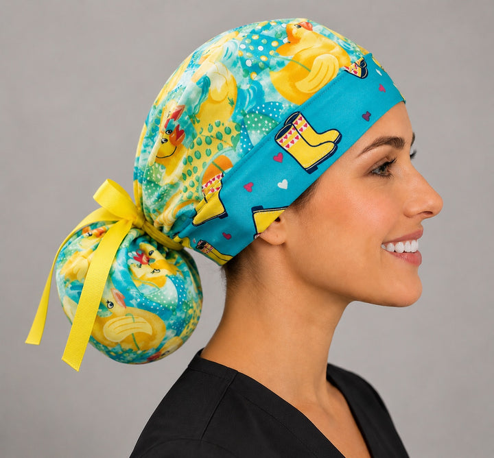 Rubber duckies rain boots ponytail surgical cap left side profile showing gathered ponytail pouch of yellow ducks with yellow grosgrain ribbon tie