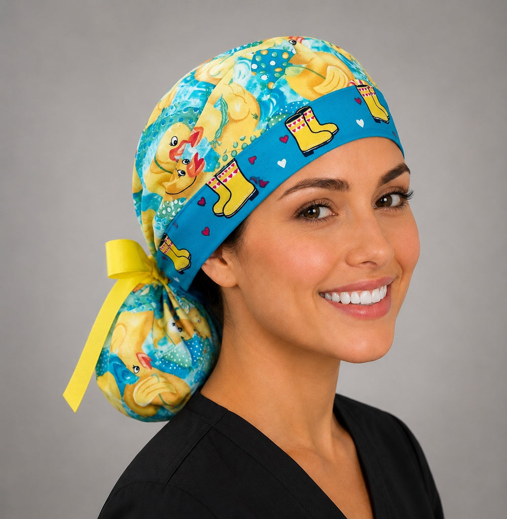 Rubber duckies rain boots ponytail nurse cap left three-quarter angle on smiling model showing yellow ducks, aqua water and yellow rain boot band with yellow ribbon bow