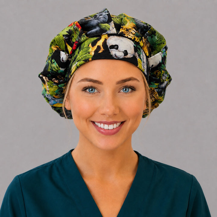 Woman wearing a safari jungle animals bouffant scrub cap, front view — tiger, giraffe, panda and elephant print, adjustable women&