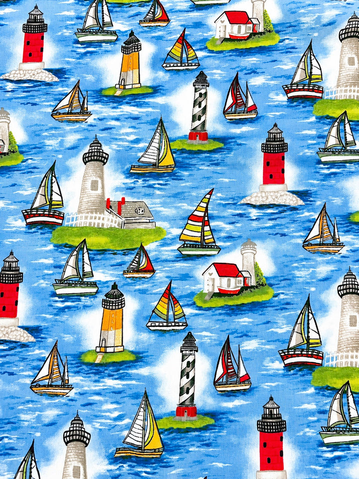 Close-up of sailboat lighthouse nautical fabric swatch, colorful coastal ocean scrub cap print detail