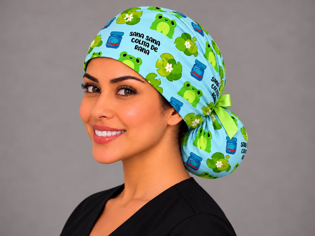 Smiling Latina nurse in a Sana Sana Colita de Rana ponytail scrub cap with lime green bow and frog print