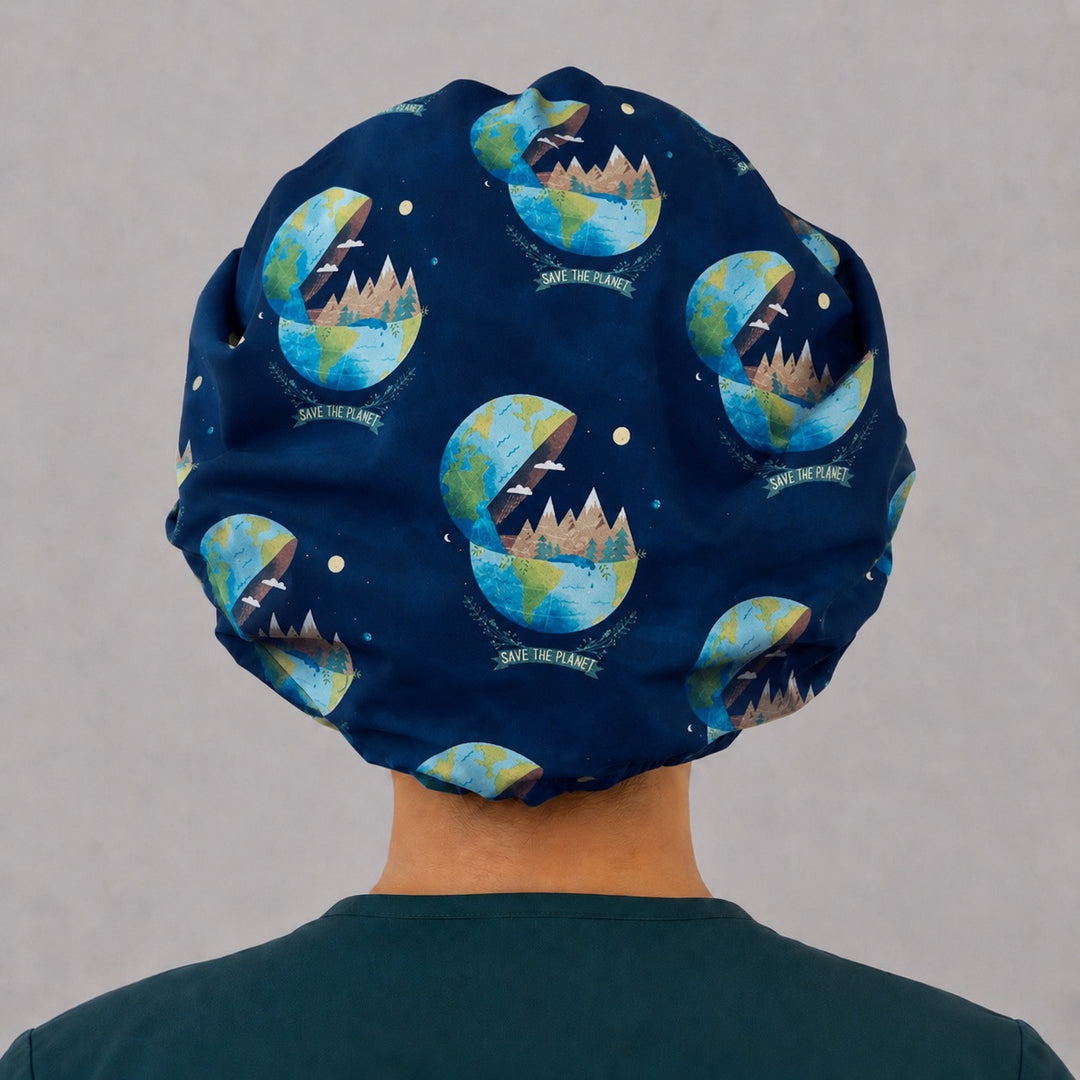 Back view of the Save the Planet bouffant scrub cap — earth globes, mountains and pines with SAVE THE PLANET banners across the navy crown