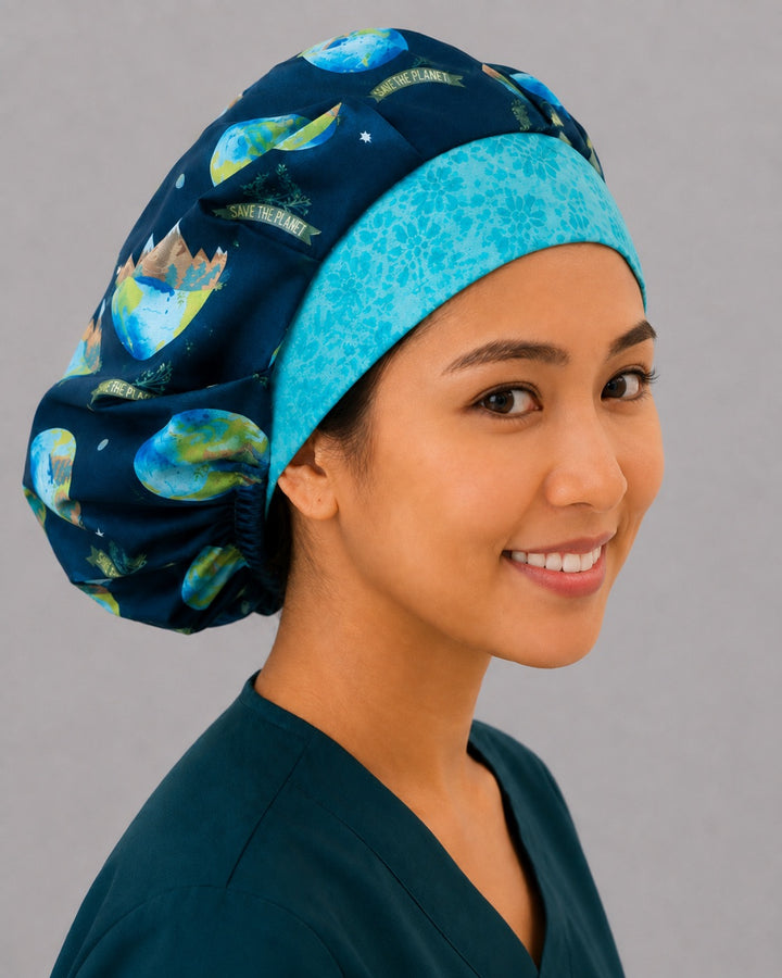 Save the Planet earth bouffant scrub cap, angled smiling view — roomy elastic-back cap that secures long thick hair for OR nurses