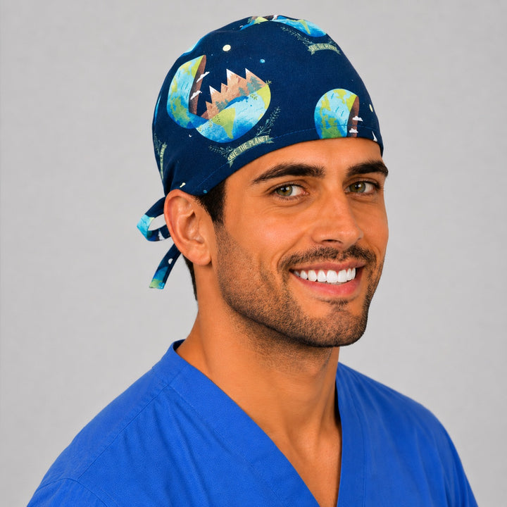 Three-quarter view of the Save the Planet scrub cap showing watercolor Earths, mountains and Save the Planet banners on navy