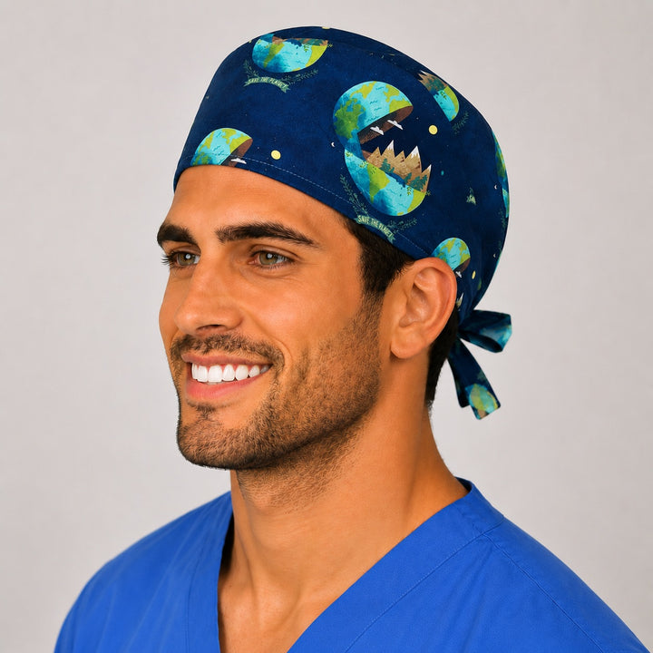 Save the Planet earth print scrub cap on a smiling male nurse, side view showing the navy Earth and trees print and tie-back