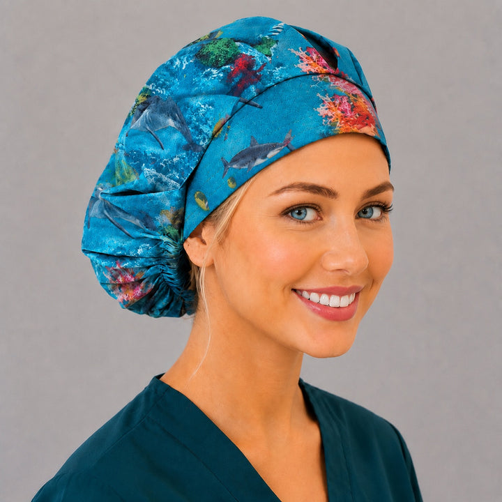 Sea life dolphin bouffant scrub cap angled view on a smiling vet tech — roomy reef print cap that secures long thick hair