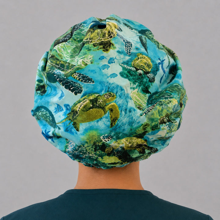Sea turtle bouffant scrub cap back view showing full ocean scene of green sea turtles, tropical fish and coral reef, OR World surgical hat