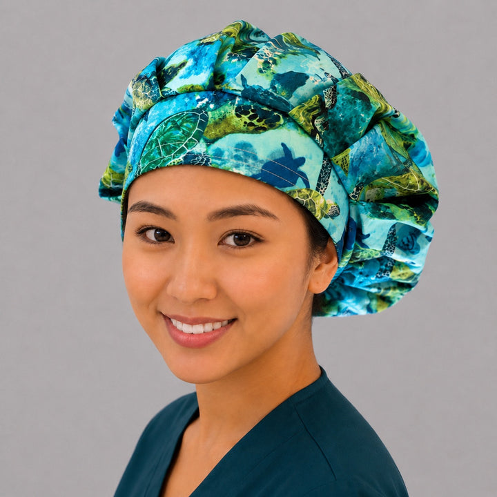 Sea turtle bouffant surgical cap right three-quarter angle on smiling model showing green sea turtles and coral reef ocean scene, OR World nurse hat